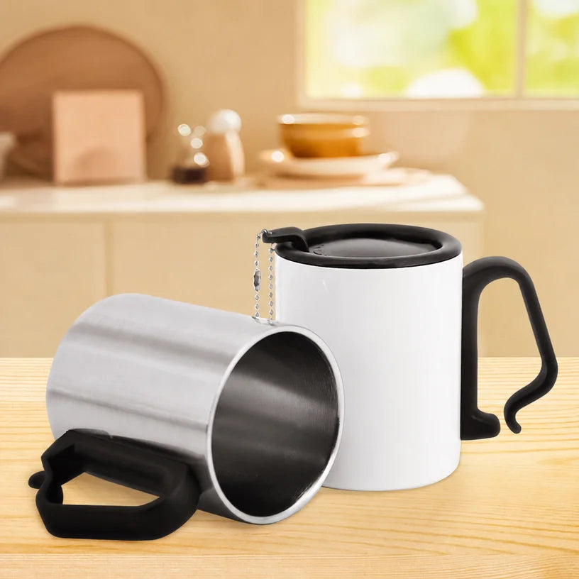 Two blank camping mugs on a wooden table, silver mug tipped to show the stainless interior