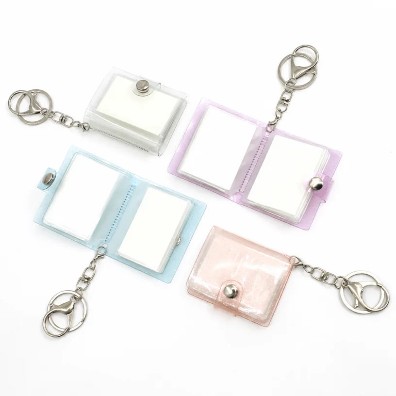 Blank photo album keychains opened flat showing the blank white photo sleeves