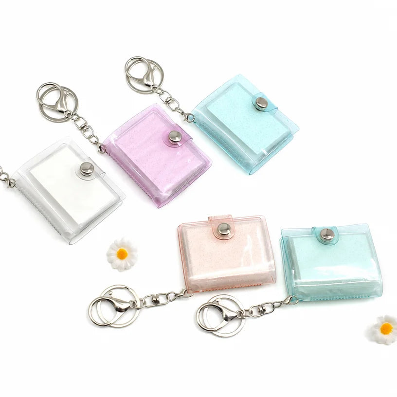 Blank mini photo album keychains in white, pink, blue and beige marbled glitter covers