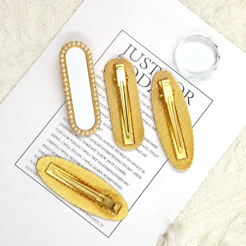 Blank pearl edged hair clips shown from the front and from the gold ribbed clip back