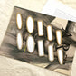 Ten blank metal hair clips in five shapes with rhinestone and pearl edging