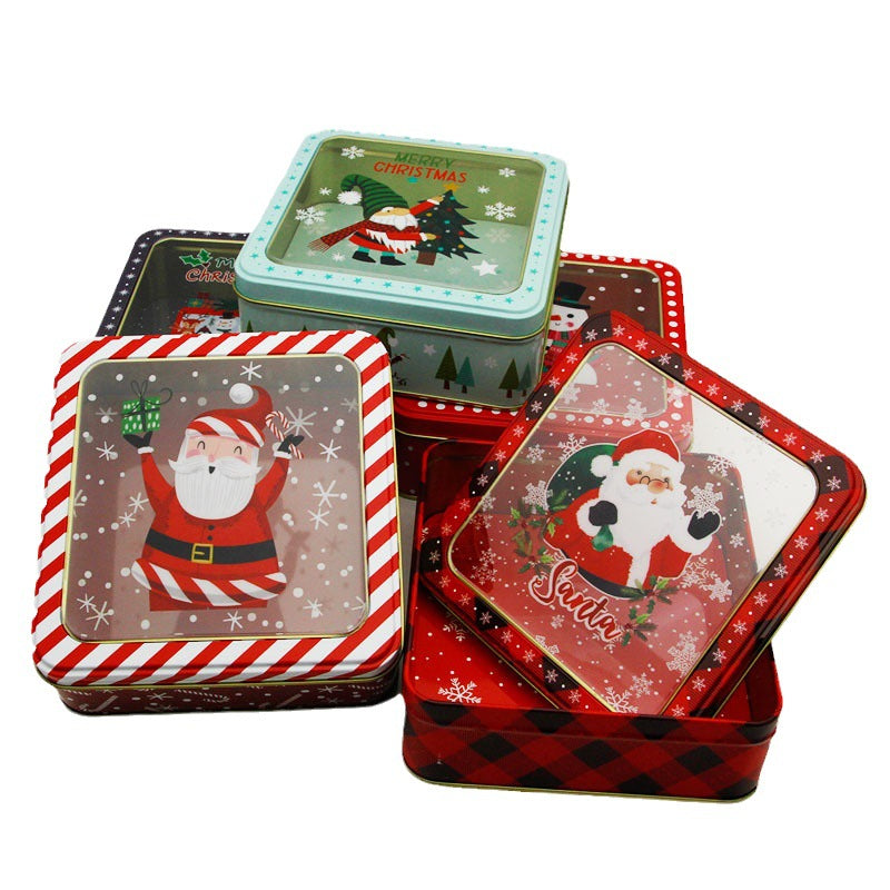 Six printed Christmas tin boxes with window lids arranged on a white background