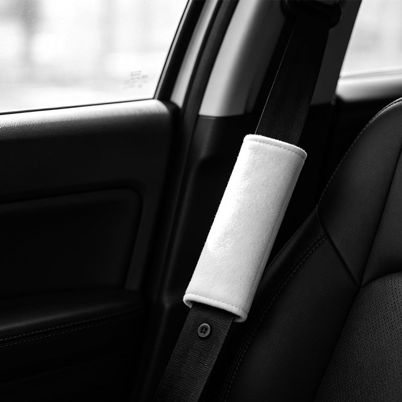 Blank white seat belt cover fitted on a car seat belt inside a vehicle