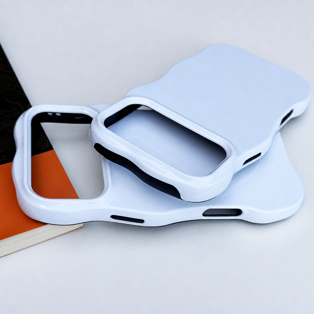 Blank wavy phone case resting on a book, angled view