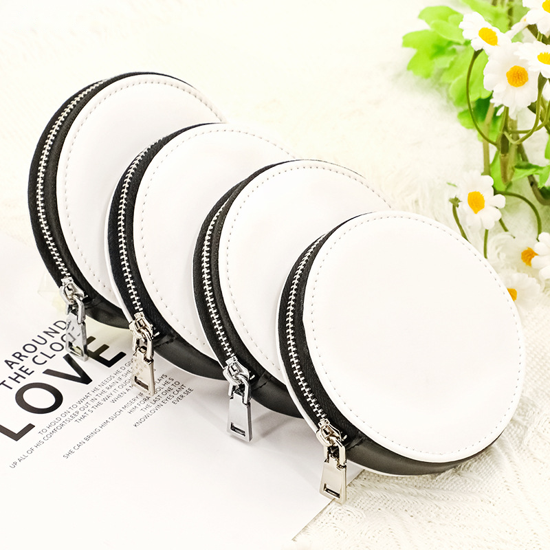 Four blank white mini storage pouch keyrings styled with a card, lace and flowers