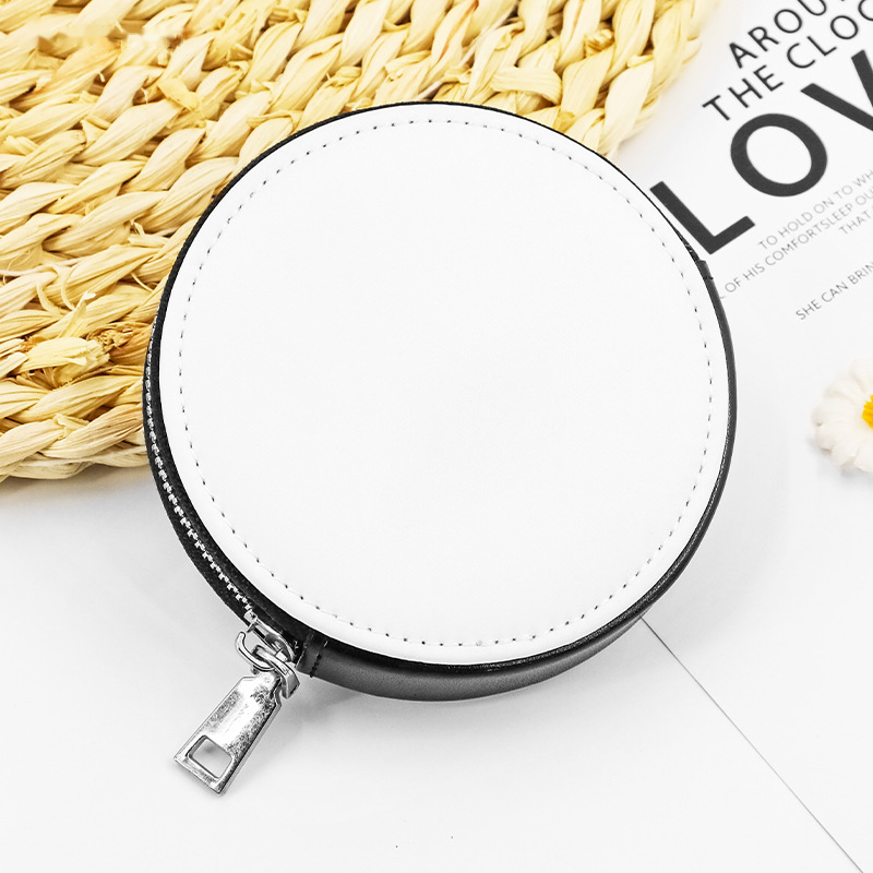 Close-up of a blank white PU leather storage pouch keyring on a woven straw mat